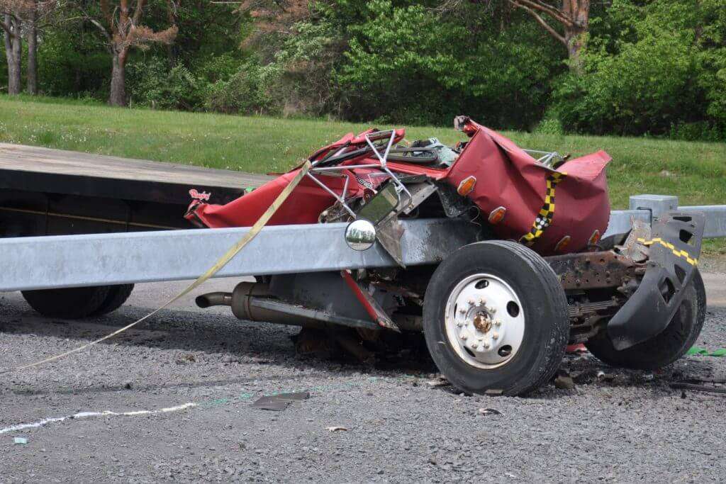 a car crashed against an anti ram security fence