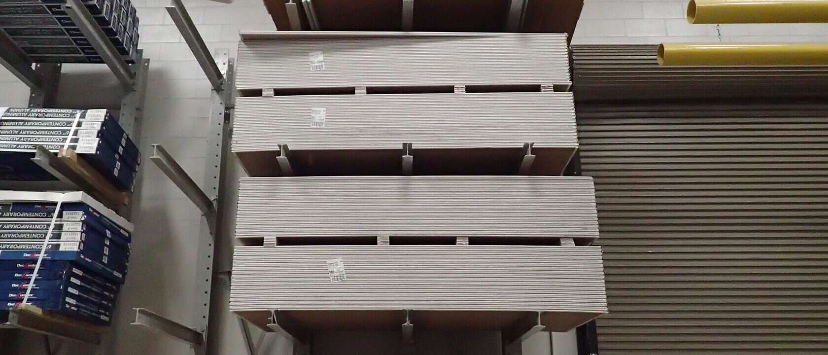 a wall of drywall panels in storage